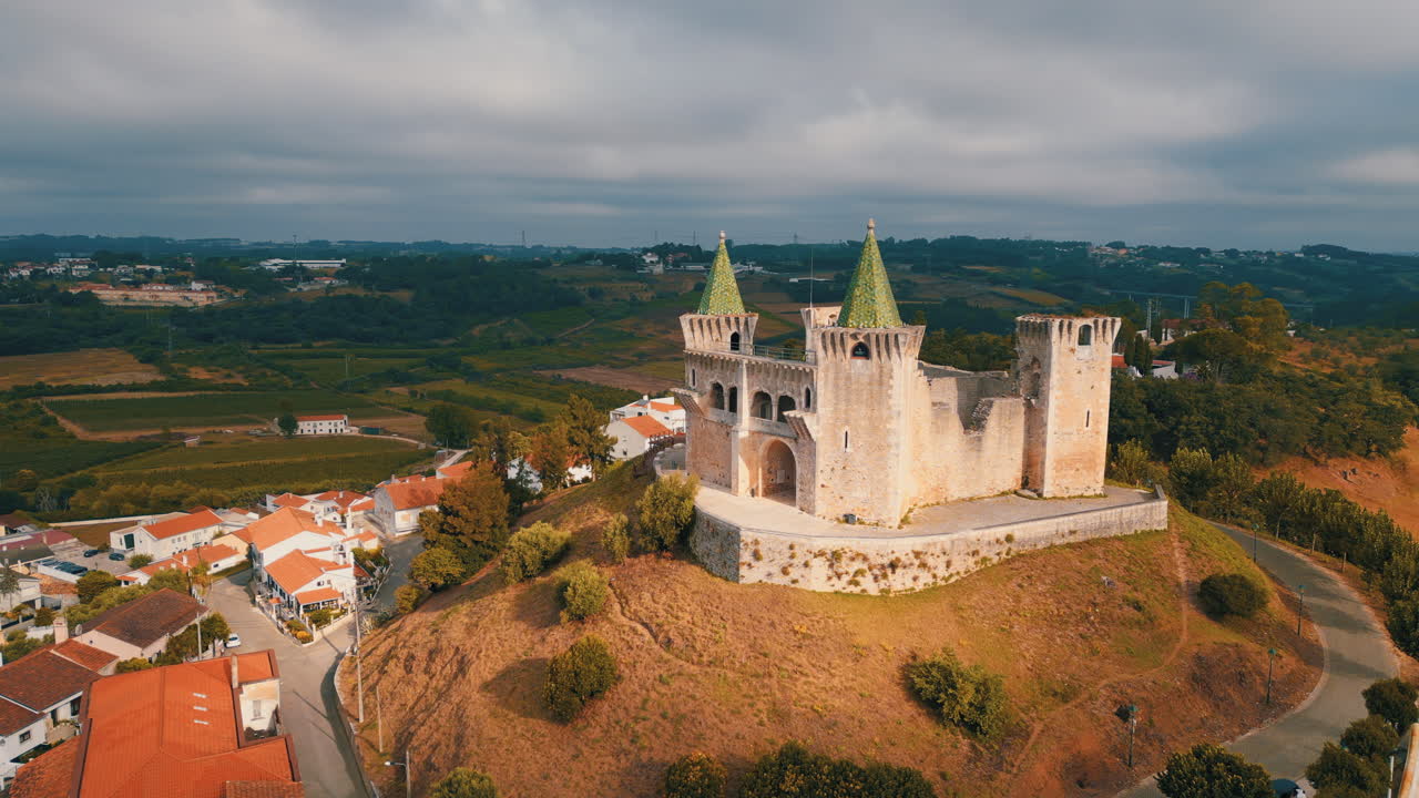 Majestic Castle of Porto de Mos standing on a hill, overlooking the surrounding countryside and village