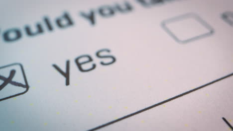 slow-motion close-up over the checked yes box on official form white document, voting, decisions, choices of yes or no checkbox