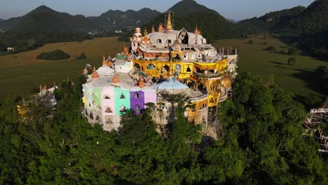 brightly colored temple on top of the hill