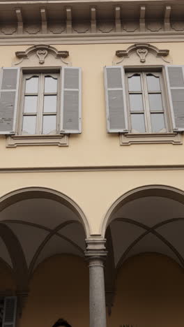 architectural detail of a building facade with windows and arches
