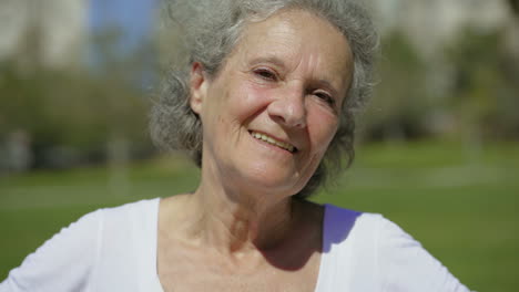 happy beautiful elderly lady smiling on camera.