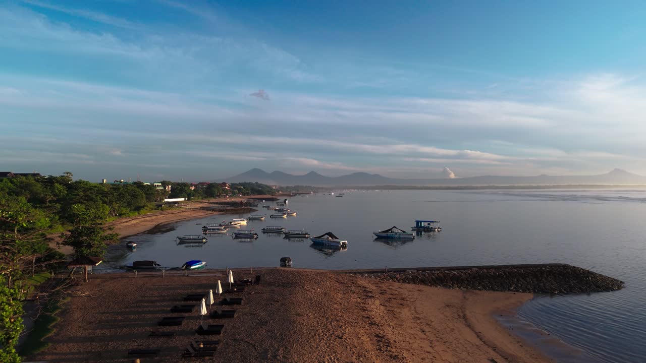 Coastal landscape of Indonesia with moored boats, aerial side fly view