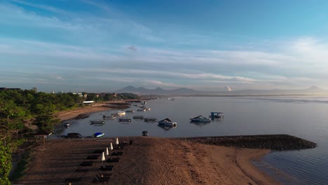 coastal landscape of indonesia with moored boats, aerial side fly view