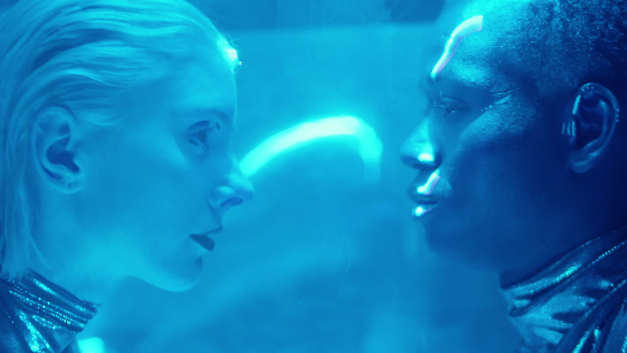 Alien Couple in Laser Beams and Blue Neon Light