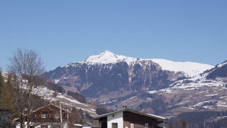 snowy mountain peaks over alpine village in spring