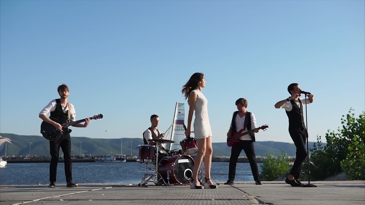 Band Performing Live on a Pier