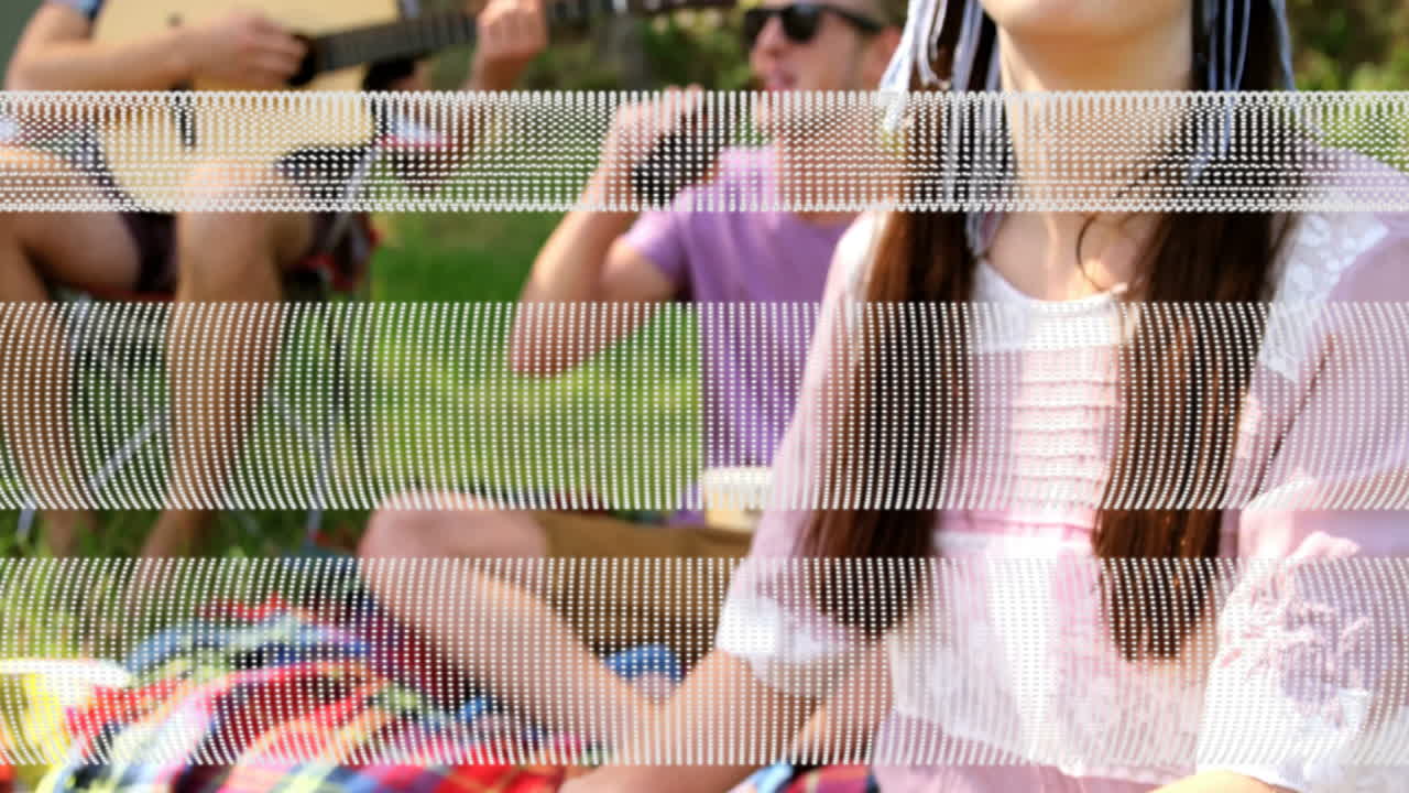 People enjoying outdoor picnic with guitar and drinks, over glitch effect animation