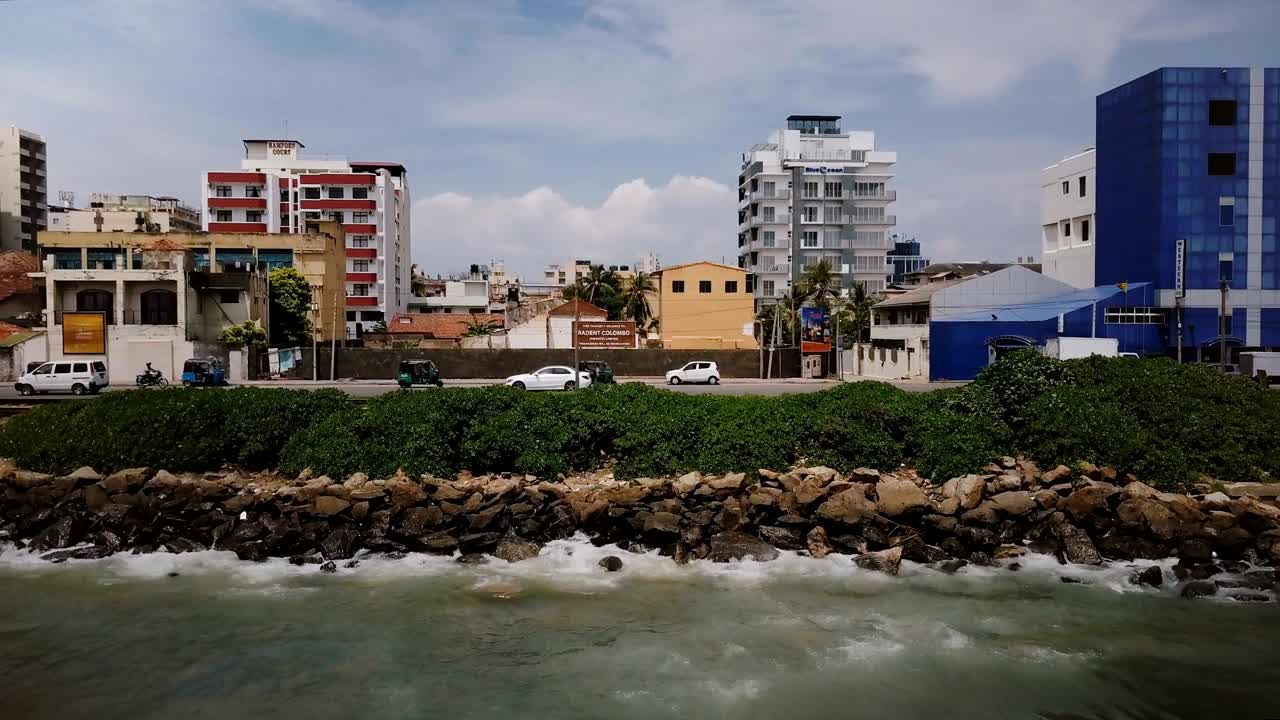 drone volando a la izquierda a lo largo de la calle ocean shore en colombo, sri lanka. fotografía de seguimiento aéreo de la ciudad turística asiática sea coast