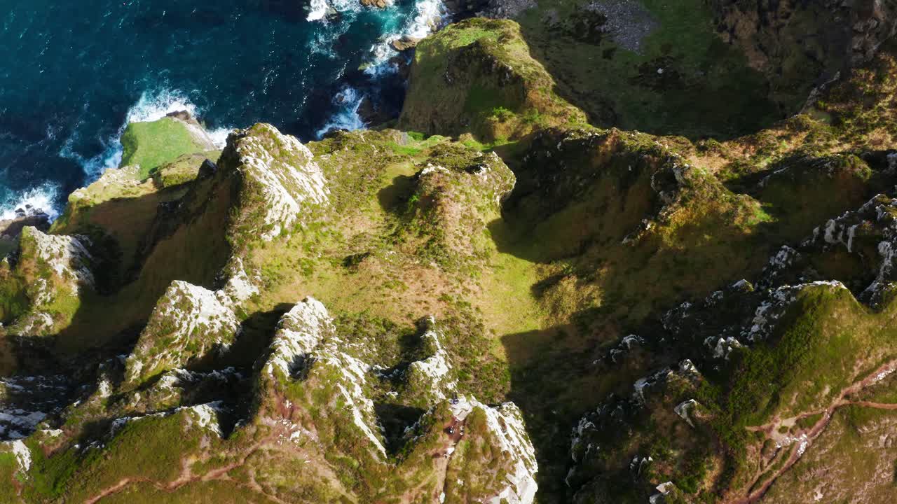 Top-down view of dramatic Horn Head cliffs with foamy Atlantic waves