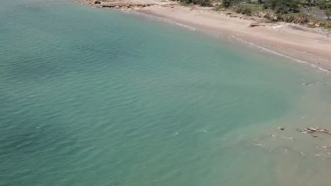 Flying-over-stunning-blue-beach-in-Darwin