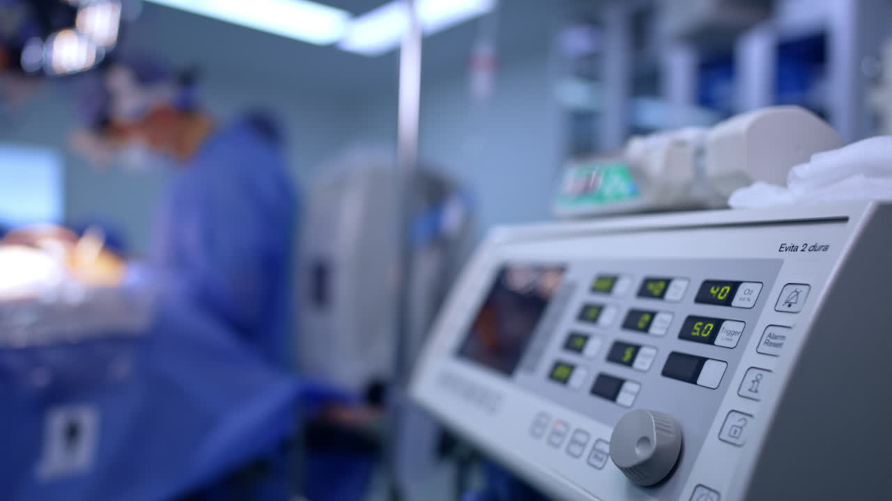Attrezzatura medica in sala operatoria durante un intervento di neurochirurgia. Dettaglio di un dispositivo medico moderno nella sala operatoria di un ospedale. Un team di neurochirurgia lavora sullo sfondo con strumenti sterili.