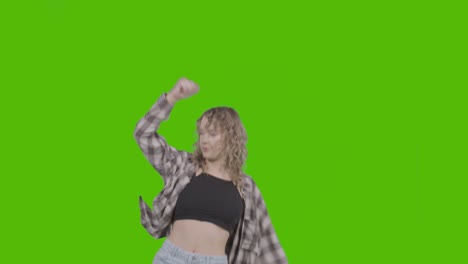 studio shot of young woman having fun dancing against green screen 3