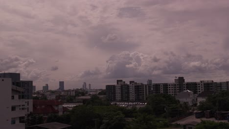 skyline of bangkok in a time-lapse shot, showing urban buildings and dramatic clouds