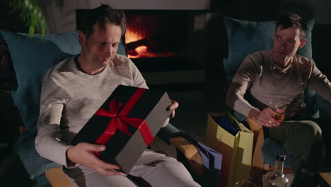 friends opening gifts by the fireplace