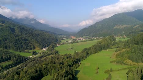 alpine nature, aerial drone view over slovenian countryside, towards a small town, near kranjska gora town and trigolov national park, on a sunny summer day, in the julian alps, slovenia