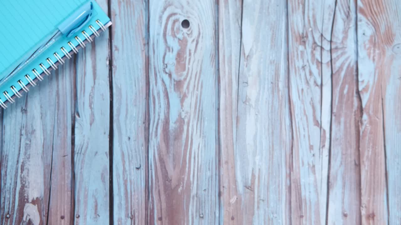 Tea and notebook on wooden table
