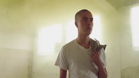 fashionable young man in an abandoned warehouse