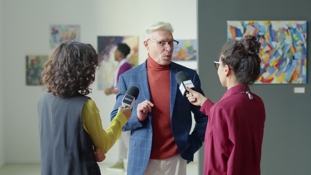 Artist Giving Interview to Journalists in Gallery