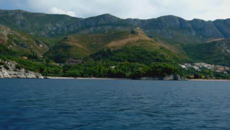 coastal mountain scenery with beach and people