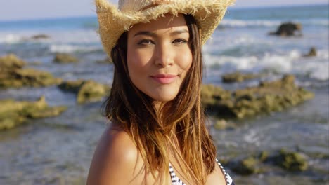 happy pretty young woman on a rocky seashore