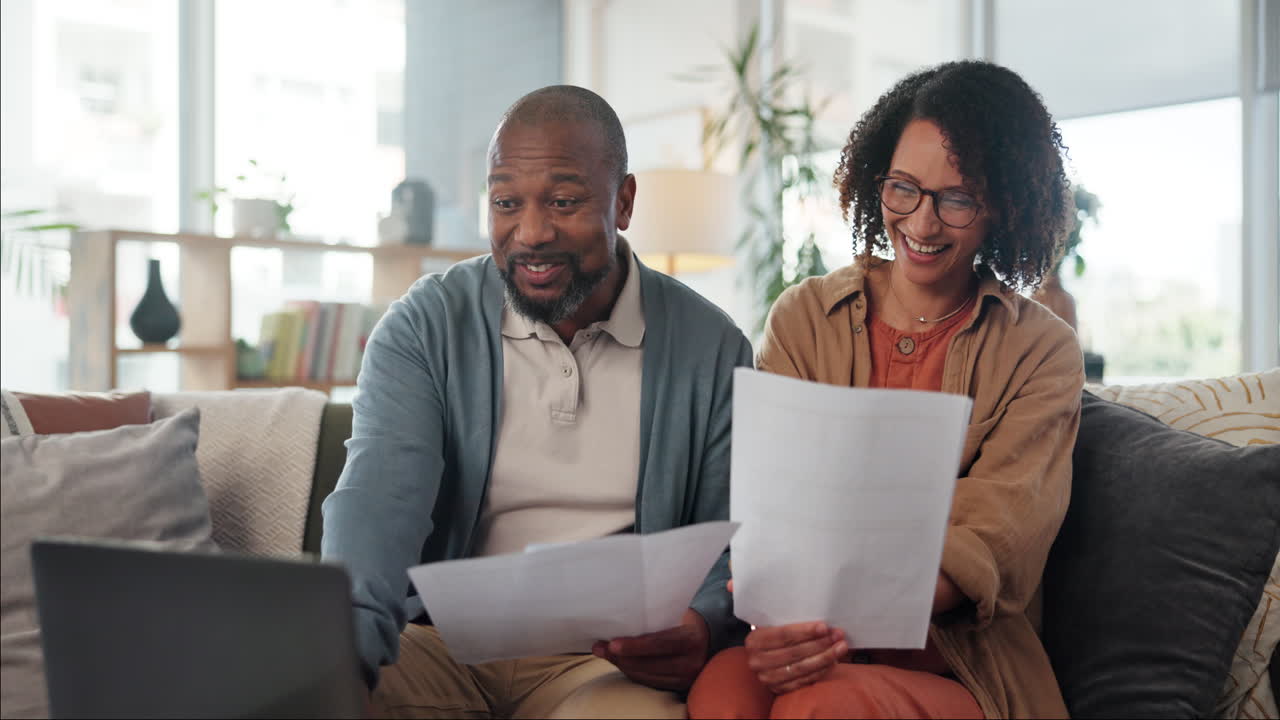 Happy Couple Reviewing Documents at Home
