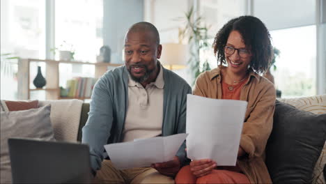 happy couple reviewing documents at home