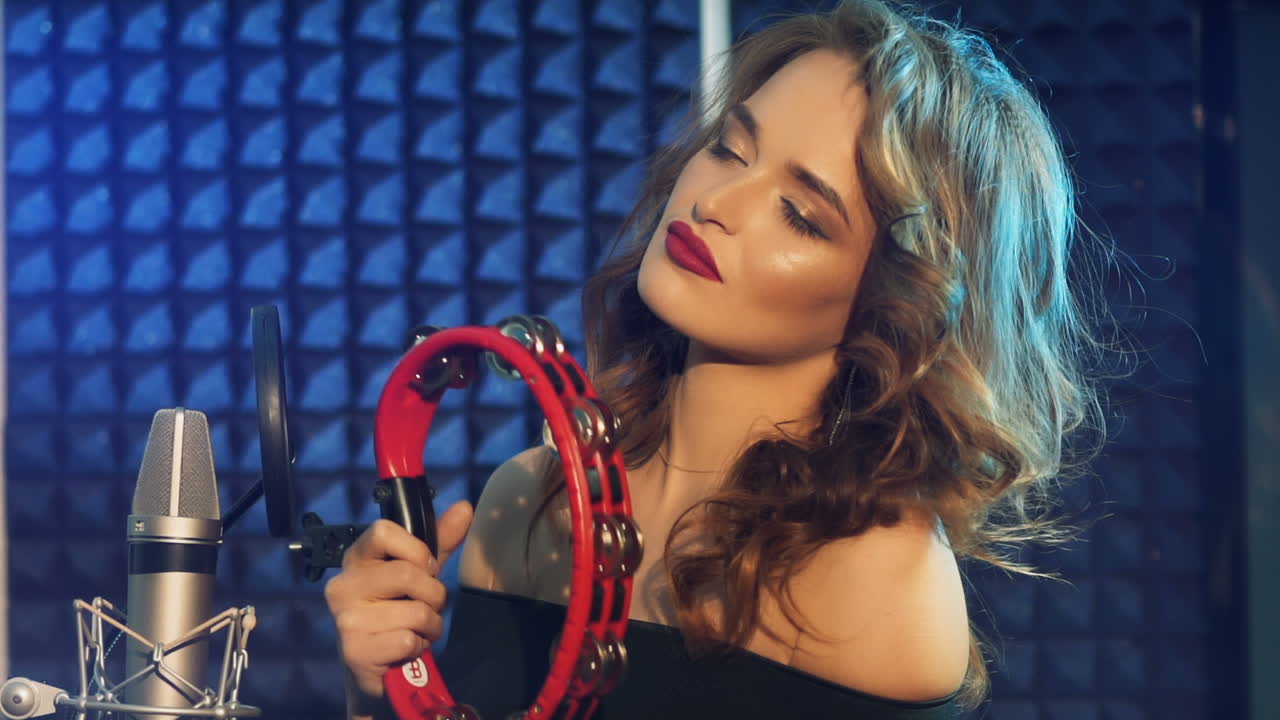 Woman singing in a recording studio. Female vocals. Professional recording studio. Slow motion