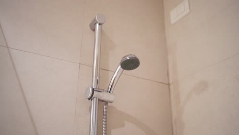 shower head mounted on tiled bathroom wall in a modern household setting, patagonia, argentina.