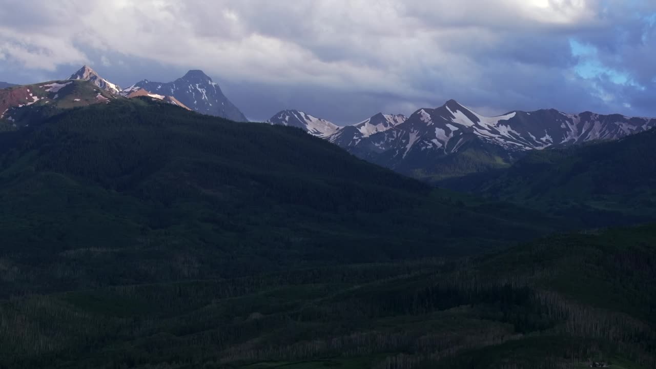 Capital Peak Old Mount Snowmass Resort Colorado aerial drone dark clouds sunset Mt Sopris Sopras Maroon Bells Aspen Wilderness summer June July Rocky Mountains peaks National Forest forward upward