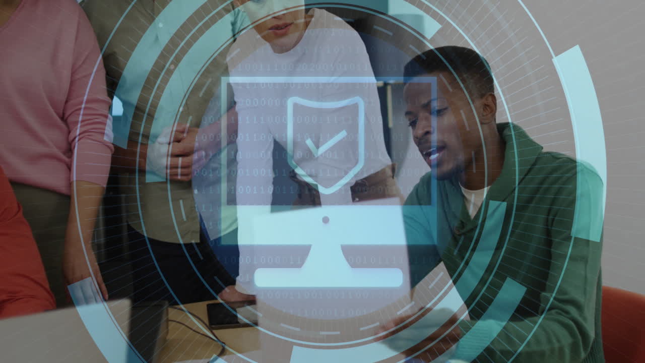 Discussing cybersecurity, diverse team in office with digital shield animation overlay