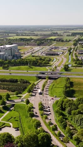 aerial view of a highway interchange with cars and surrounding green landscape
