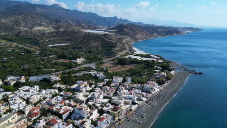 drone aerial of beach in crete, greece at city mirtos