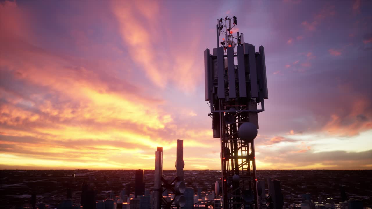 A Tall Cell Tower Stands Against A Vibrant Sunset