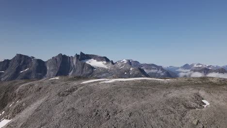 Rough-Mountain-With-Snow-And-Clouds-In-Romsdalen,-Norway-On-A-Sunny-Day