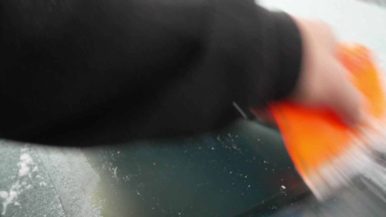Scraping ice off car window