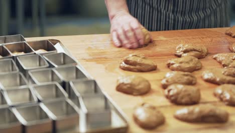 the-baker-kneads-the-dough-into-buns-and-puts-them-into-shape-before-baking