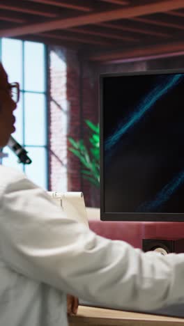 vertical video woman listening and watching business conference on computer screen
