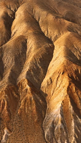 Amazing rock formations with no plants growing on. Drone approaching mountains in Nevada, USA. Vertical video