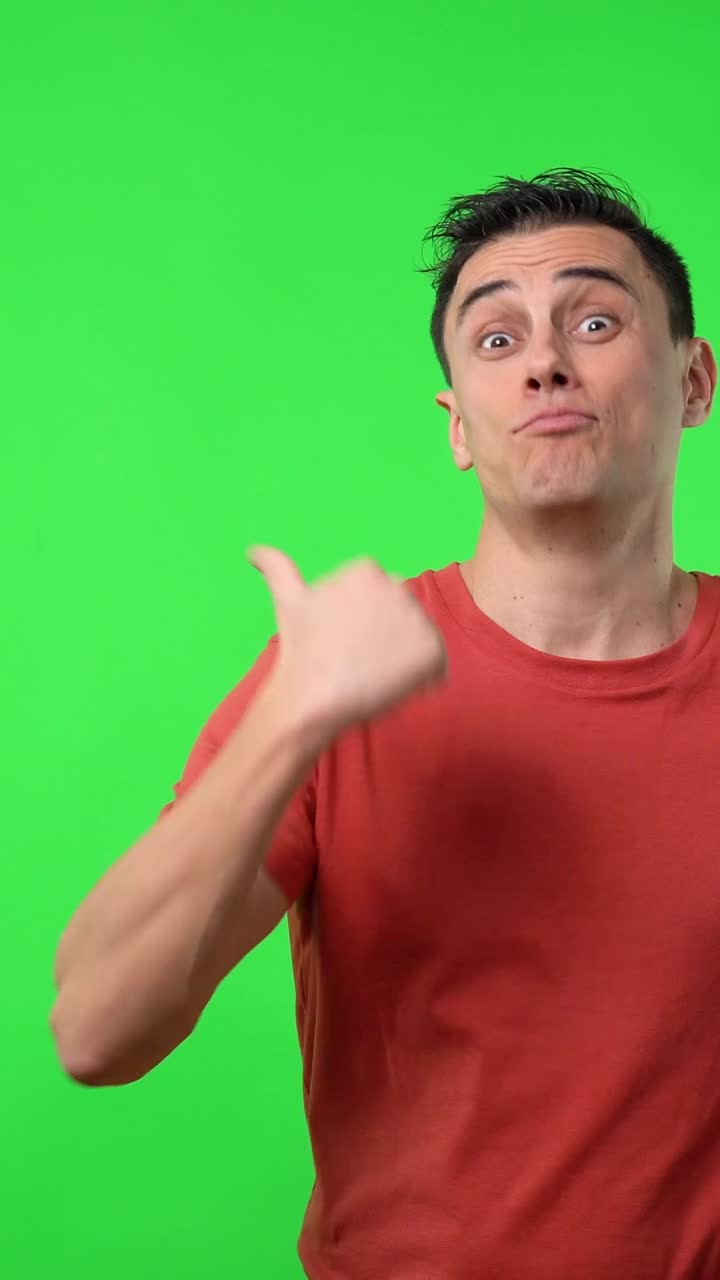 Man in red shirt pointing on green screen