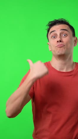 Man in red shirt pointing on green screen