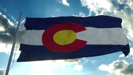 colorado flag on a flagpole waving in the wind in the sky. state of colorado in the united states of america