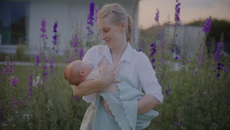 happy mother holding baby at sunset