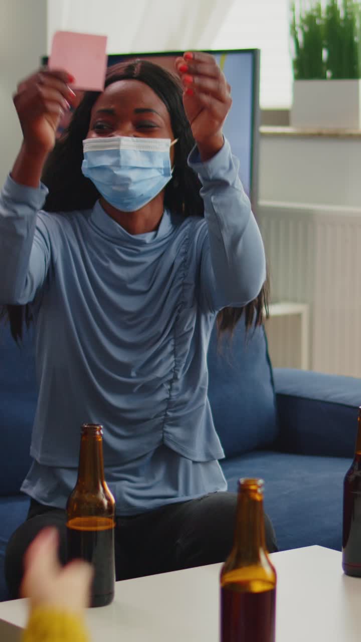 Vertical video: Mixed people with sticky notes on foreheads playing name game