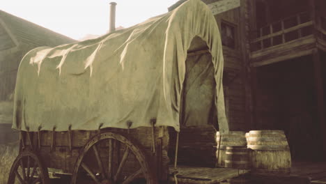 Vintage wagon on wooden wheels near barrels in a rustic setting