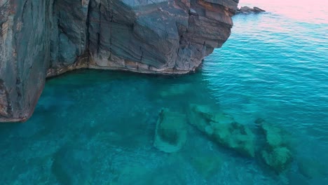 Aerial-forward-drone-shot-over-the-calm-sea-during-blue-hour-in-Greece