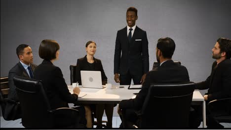 Multiple-screen-showing-businesspeople-having-meeting-