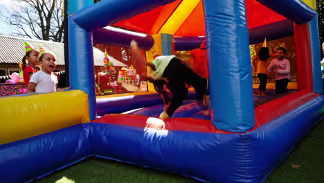 kids jumping in a colorful bounce house