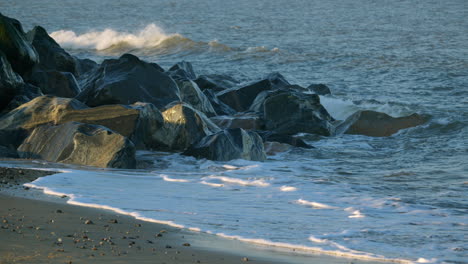 mid shot of the sea gently crashing over sea defence rocks on the beach at caister on sea