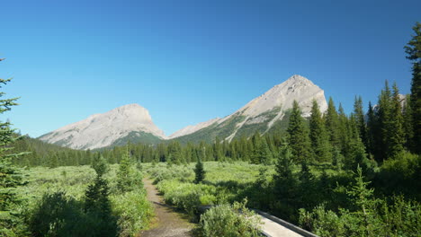 Beautiful-Landscape-of-Mount-Assiniboine-Canada-on-Sunny-Summer-Day,-Wooden-Bridge-and-Hiking-Trail