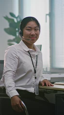 smiling asian woman customer service agent in office